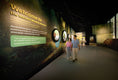 Cargar la imagen en la vista de la galería, Visitors walking through the Mandai Wildlife Reserve welcome gallery
