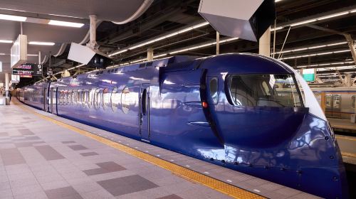 The dark blue Nankai Rapi:t limited express waiting at a platform