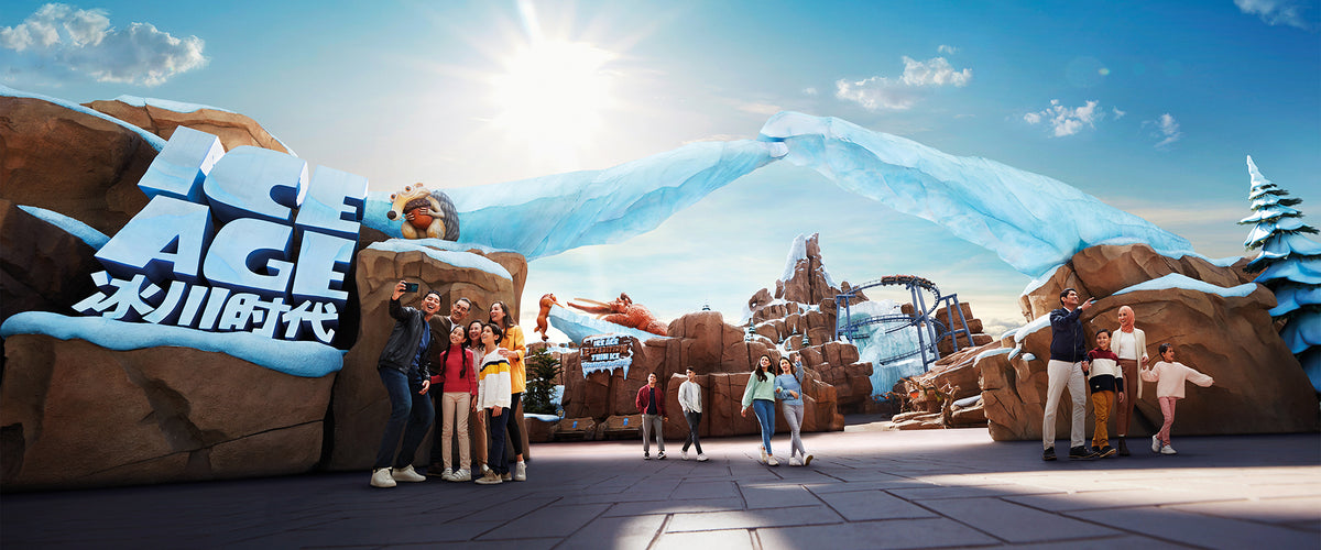 Visitors posing in front of the Ice Age zone entrance, built as a glacier face.
