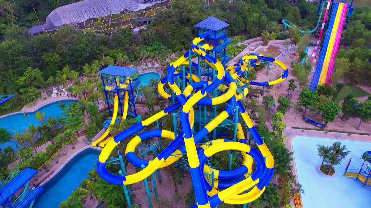 Aerial view of the blue and yellow tube slides and pools of the ESCAPE waterpark.