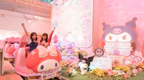 Two visitors riding the My Melody and Kuromi attraction at Sanrio Puroland