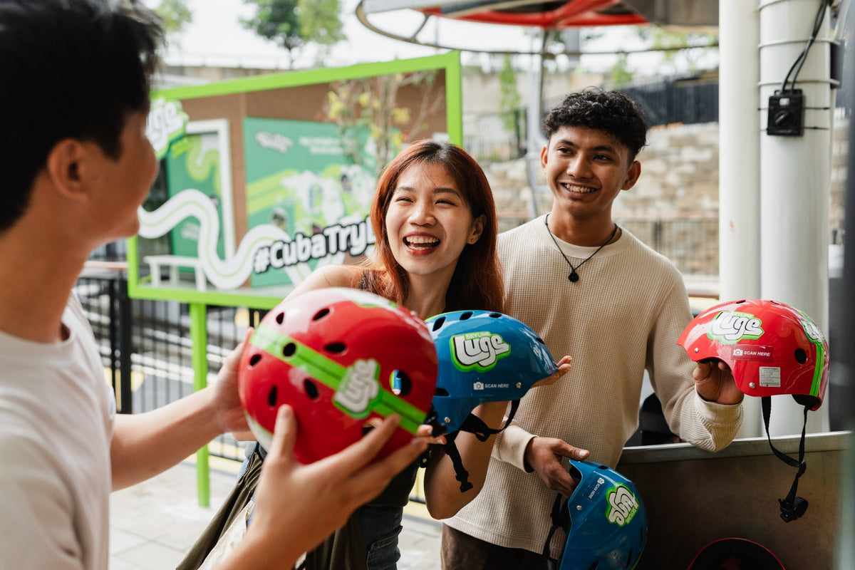 Visitors collecting helmets at the counter before their run.