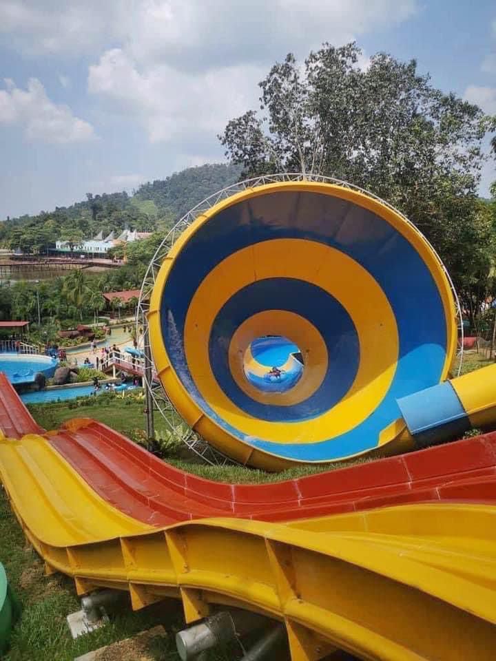 A large blue and yellow funnel slide seen head on, a rider dropping through the centre.
