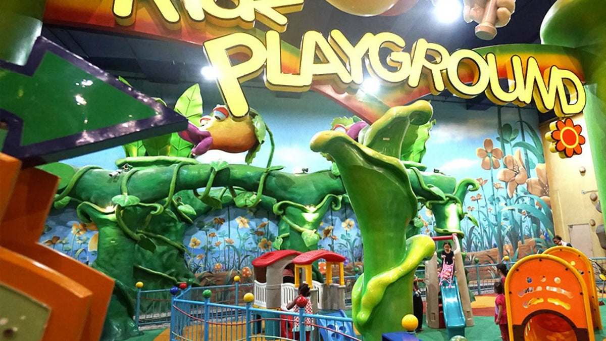 A soft-play area themed as a green jungle playground for younger children.