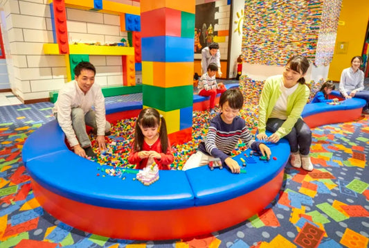 Families building with LEGO bricks in an indoor play area at LEGOLAND Japan